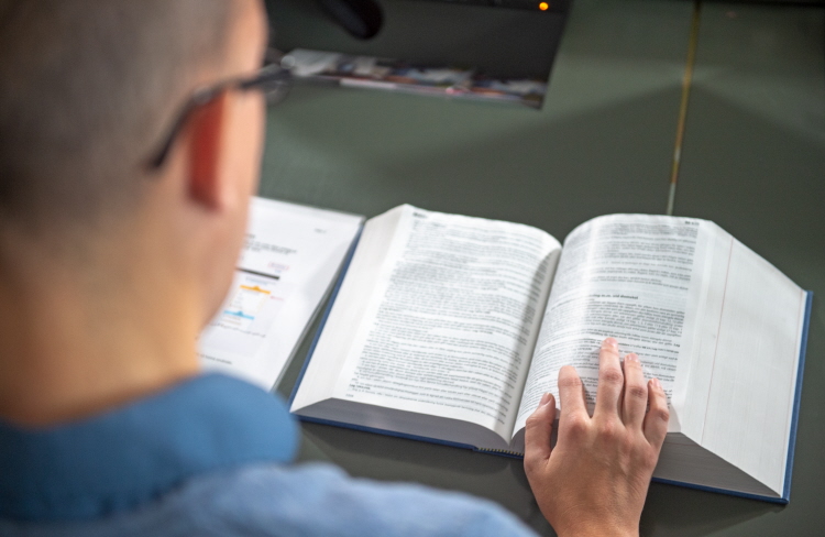 A person reading the book of swedish laws