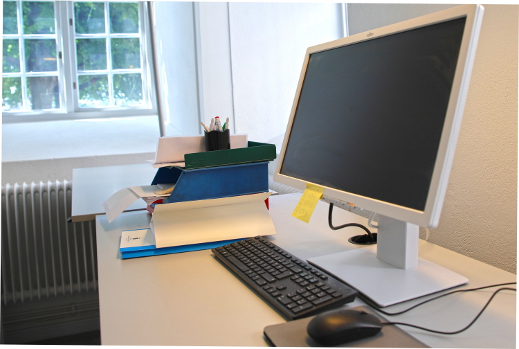 A desk with a computer screen