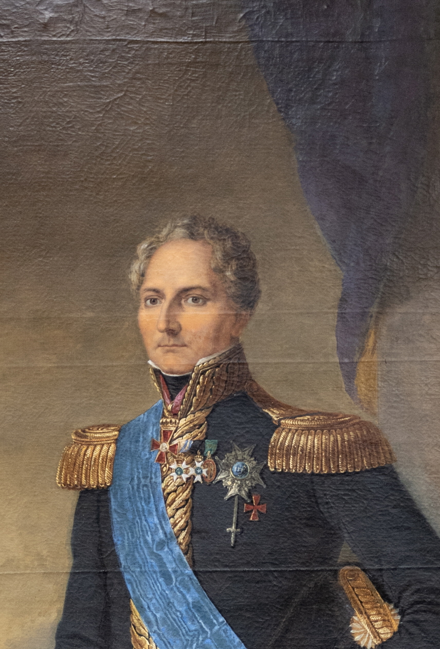 Målning med kung Karl XIV Johan stående i uniform i ett rum med silvertron i bakgrunden.